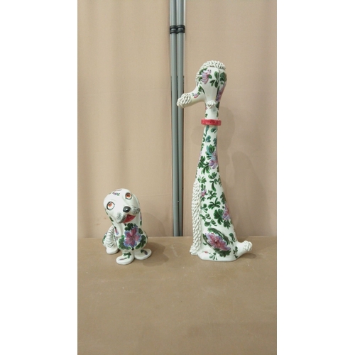 42 - Pair of ceramic dog figurines, hand-painted with floral motifs. Featuring intricate textures and vib... 