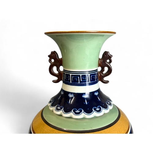 25 - A large Chinese porcelain vase.Celadon ground with central painted panel depicting fenced garden sce... 