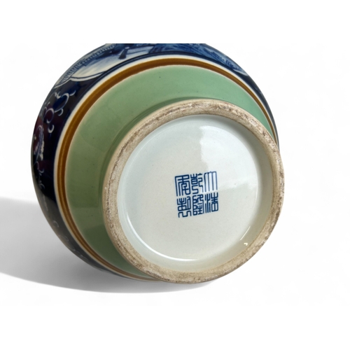 25 - A large Chinese porcelain vase.Celadon ground with central painted panel depicting fenced garden sce... 