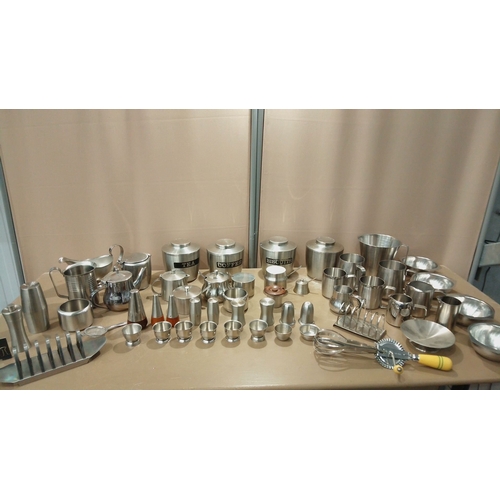 102 - Collection of brushed stainless steel kitchenware, including tea and coffee canisters, serving jugs,... 