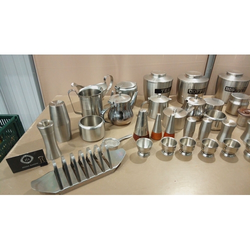 102 - Collection of brushed stainless steel kitchenware, including tea and coffee canisters, serving jugs,... 