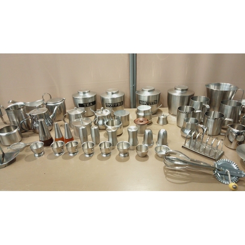 102 - Collection of brushed stainless steel kitchenware, including tea and coffee canisters, serving jugs,... 