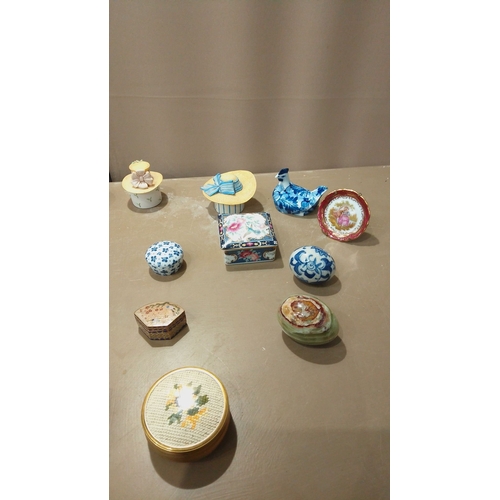 104 - Collection of 22 decorative trinket boxes, porcelain and ceramic, featuring floral, scenic, and figu... 