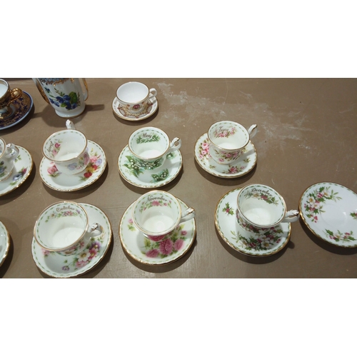 105 - Set of Monthly Floral Bone China Teacups and Saucers: Beautifully adorned Royal Albert designs for e... 