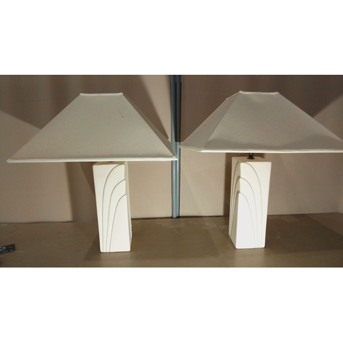 112 - Pair of modern ceramic table lamps with geometric relief design. Includes original shades and functi... 