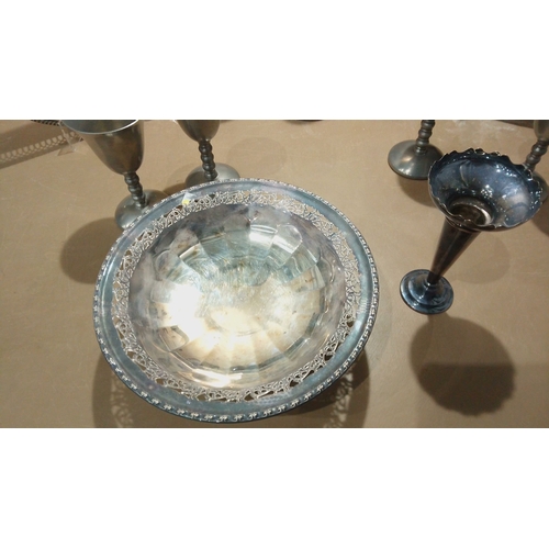 114 - Silver-plated serving set includes an ornate rectangular tray, intricately engraved round tray, and ... 