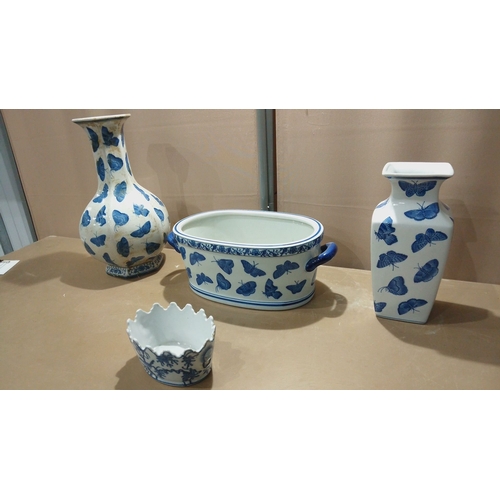 117 - Set of four porcelain pieces decorated in cobalt blue butterfly motifs, including vases, a handled d... 