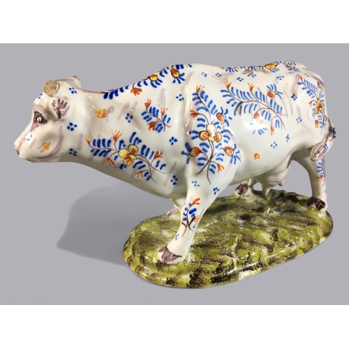 106 - Antique Faience Floral Decorated Model of a Cow. Marks and Signature to Base.H 13cm  x  L 21cm.... 