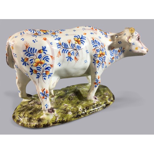 106 - Antique Faience Floral Decorated Model of a Cow. Marks and Signature to Base.H 13cm  x  L 21cm.... 