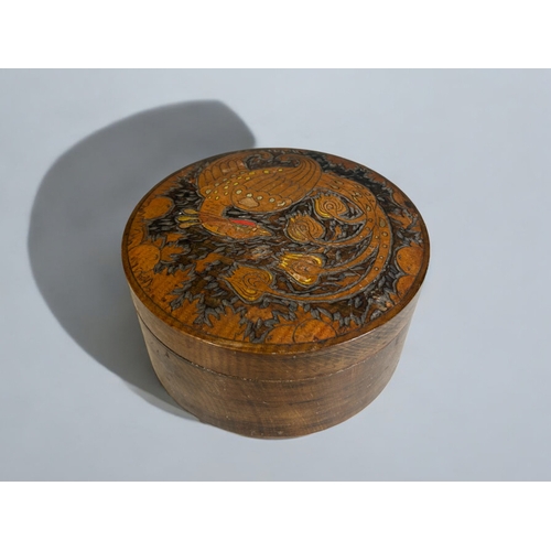 38 - An Oriental hand carved wooden box.The lid carved & painted with a Ho Ho bird.8 x 15cm... 