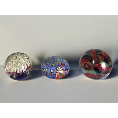 37 - A collection of twelve glass paperweights.