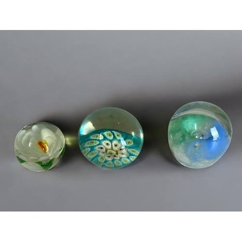 37 - A collection of twelve glass paperweights.