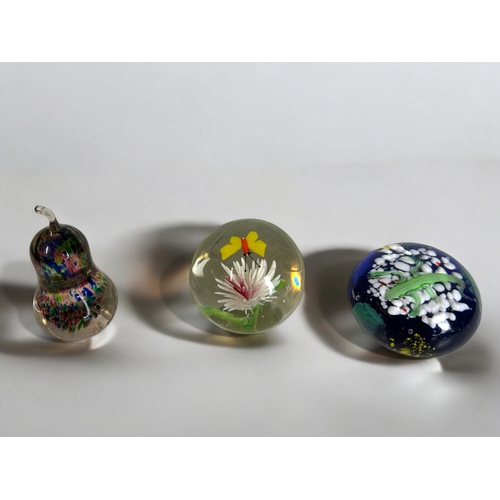 37 - A collection of twelve glass paperweights.