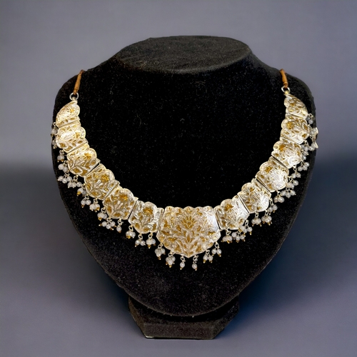 215 - A PERSIAN? WHITE & GILT METAL ENAMELLED CHOKER NECKLACE. Stylised foliate design, with drop pear... 