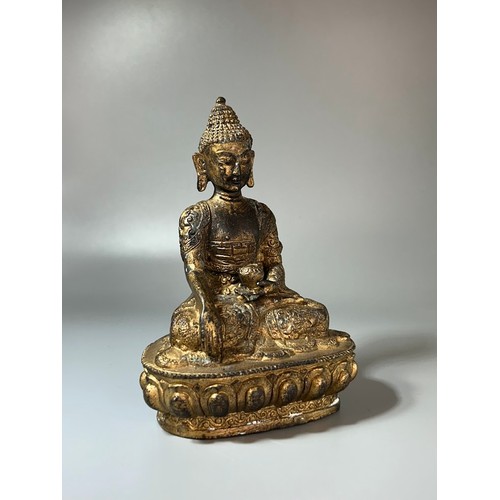 343 - A Chinese Gilt bronze Shakyamuni Buddha.18th/19th Century.Robes adorned with scrolling Dragons.Heigh... 