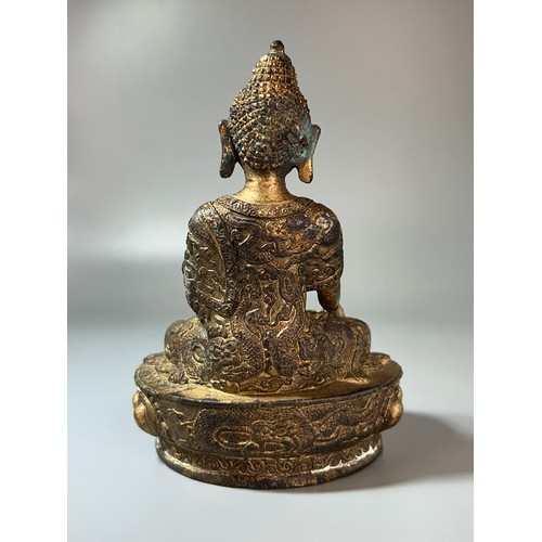 343 - A Chinese Gilt bronze Shakyamuni Buddha.18th/19th Century.Robes adorned with scrolling Dragons.Heigh... 