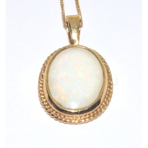 123 - 9ct gold vintage Opal pendant necklace in a scroll work setting on a 39cm 9ct gold chain 