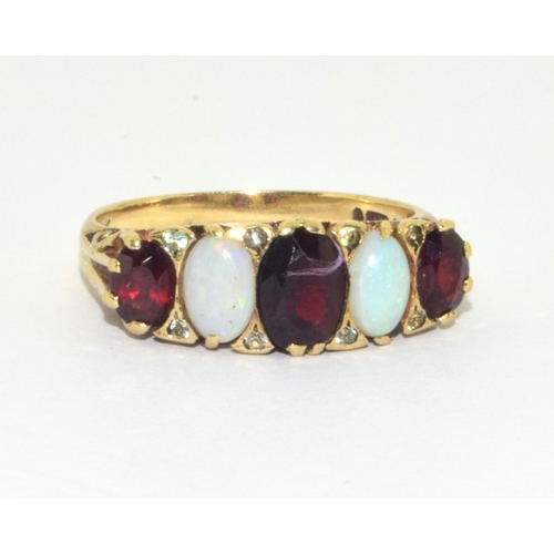 46 - 9ct gold ladies antique 5 stone Opal and Garnet ring in a heavy scroll setting size Q 3.8g