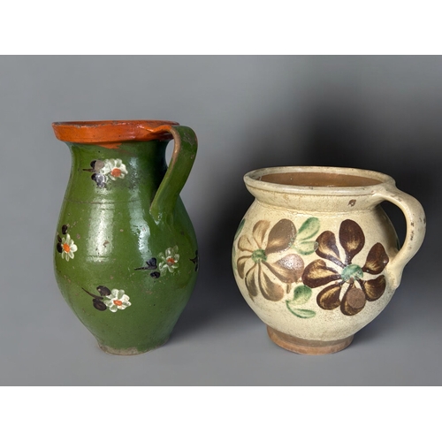 11 - Two Hungarian 'Folk Art' pottery jugs.Foliate painted.Largest - 25.5cm