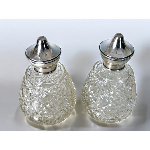 303 - Three silver topped cut glass bottles.Including larger 'Reynolds Angles' bottle, Henry Mathews, 1906... 