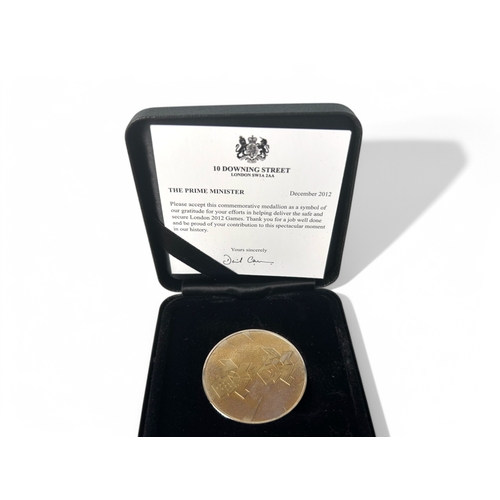 382 - Two 2012 London Olympics commemorative medallion.Prime minister thank you. In original box.Together ... 