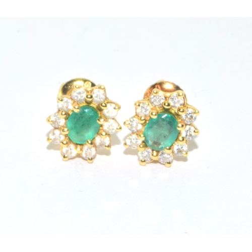 155 - Superb quality 18ct gold Emerald and Diamond halo design earrings each with screw back and butterfli... 