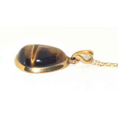 73 - 9ct gold large Tigers Eye pendant necklace on a 9ct gold chain of 48cm