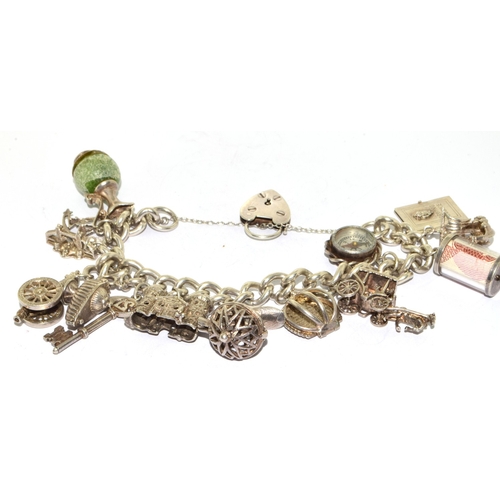 140 - Large heavy 925 silver charm bracelet and 14charms some articulated with heart padlock and safety ch... 