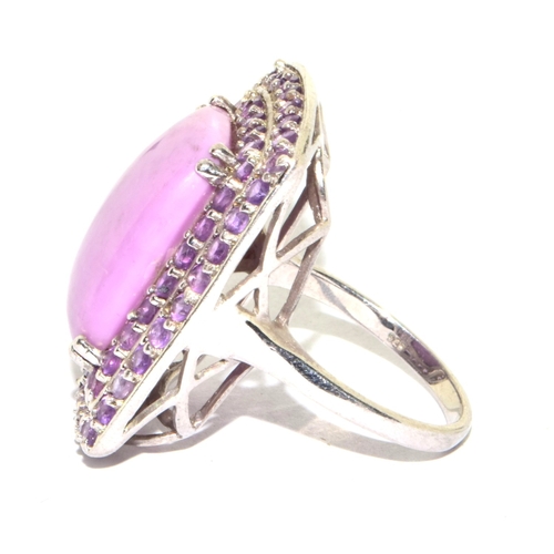 202 - 925 silver large unpolished pink tourmaline oblong centre stone with a halo of twin rows polished to... 