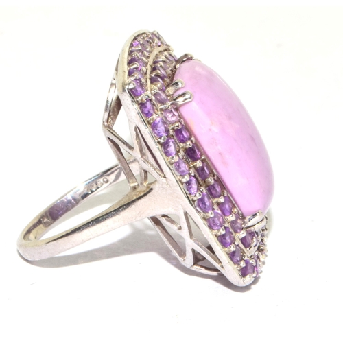 202 - 925 silver large unpolished pink tourmaline oblong centre stone with a halo of twin rows polished to... 