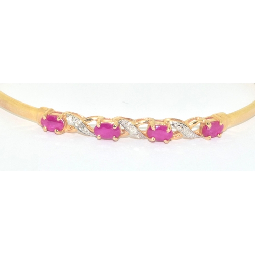 128 - 9ct gold oval cut Ruby and Diamond bangle with a Diameter of 6cm