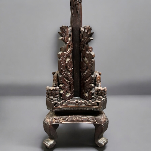 59 - A Chinese carved wood Standard floor lamp.Late 19th / 20th century.Carved with stylised Dragons and ... 