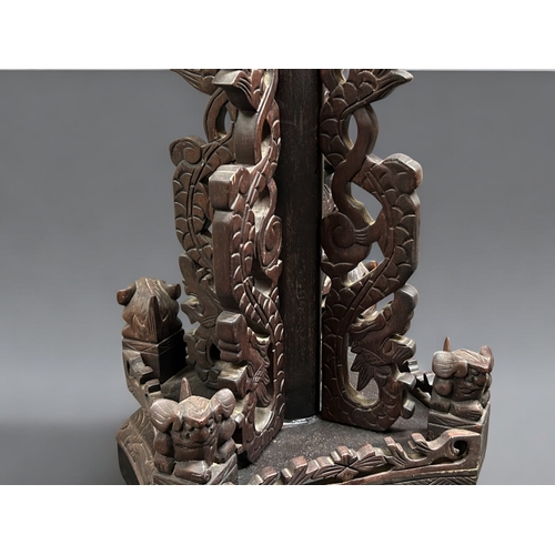 59 - A Chinese carved wood Standard floor lamp.Late 19th / 20th century.Carved with stylised Dragons and ... 