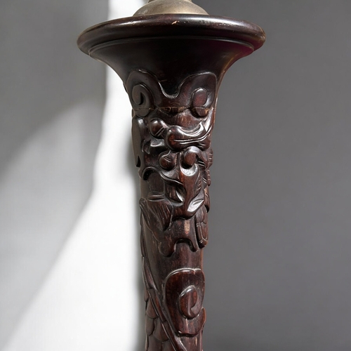 59 - A Chinese carved wood Standard floor lamp.Late 19th / 20th century.Carved with stylised Dragons and ... 
