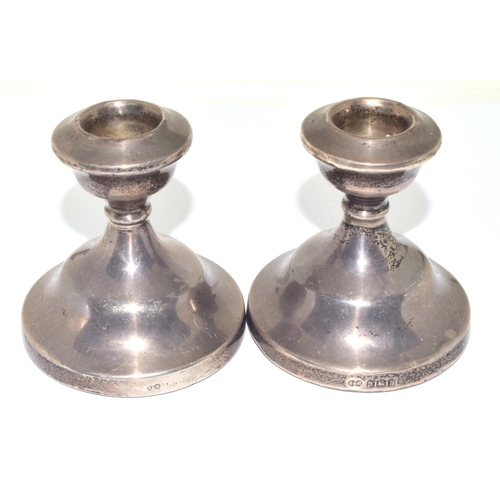 262 - Pair of silver dwarf candle sticks together a silver nap kin ring