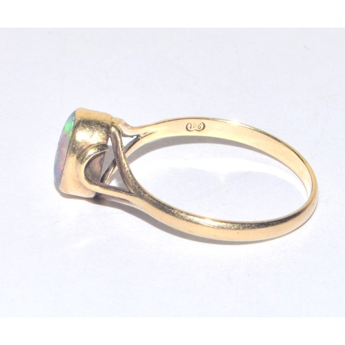 256 - 9ct gold antique cabochon cut Opal solitaire ring held in a fancy enclosed design size M