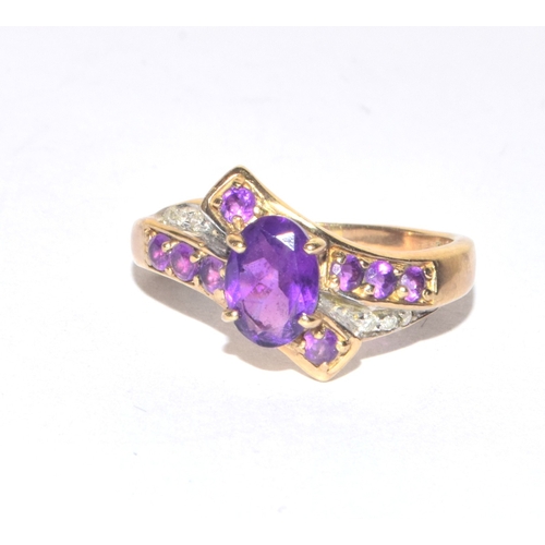 85 - 9ct gold ladies Diamond and Amethyst twist design statement ring size M