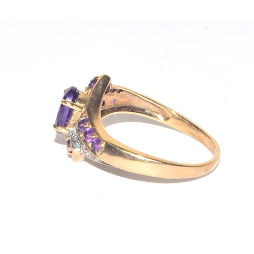 85 - 9ct gold ladies Diamond and Amethyst twist design statement ring size M