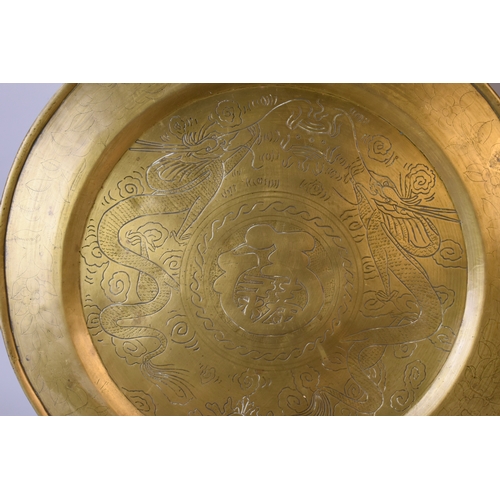 208 - Two large engraved Chinese brass trays.Circular example depicting two Dragons contesting the pearl (... 