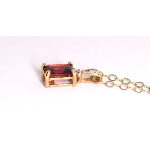 218 - 9ct gold garnet and Diamond pendant necklace on a 9ct gold chain of 40cm