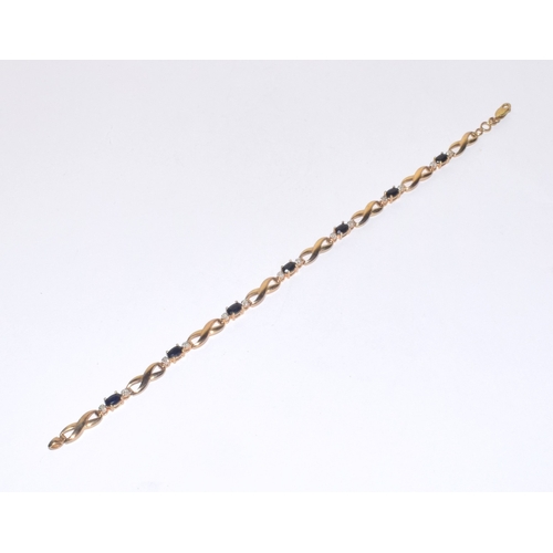 138 - 9ct gold Diamond and Sapphire line bracelet of 17cm long hall marked as diamond