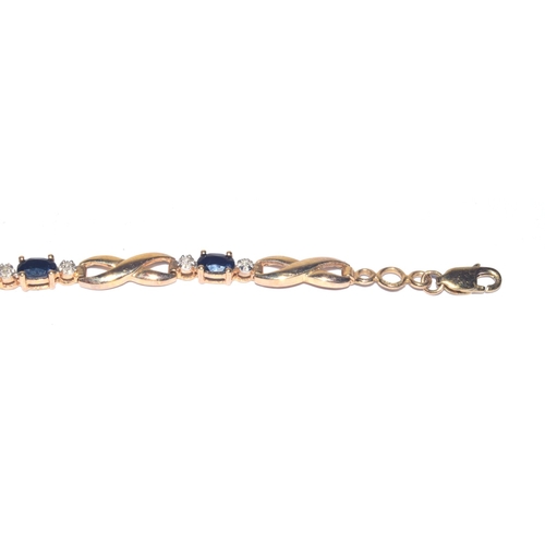 138 - 9ct gold Diamond and Sapphire line bracelet of 17cm long hall marked as diamond