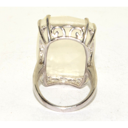 208 - 925 silver ladies large set rough clear crystal oblong single stone ring in an open scroll setting s... 