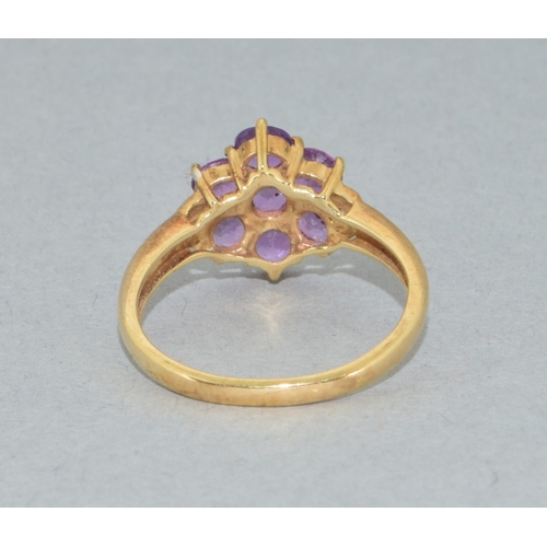 38 - 9ct gold ladies Amethyst flower head ring with accent Diamond decoration held in a claw setting size... 