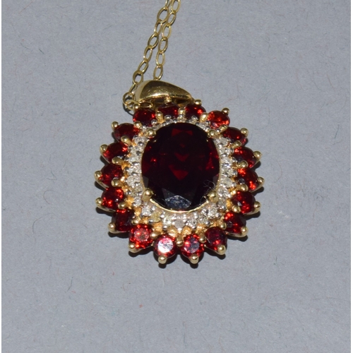 39 - 9ct gold Garnet and Diamond pendant necklace on a 9ct gold chain of 40cm long