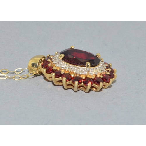 39 - 9ct gold Garnet and Diamond pendant necklace on a 9ct gold chain of 40cm long
