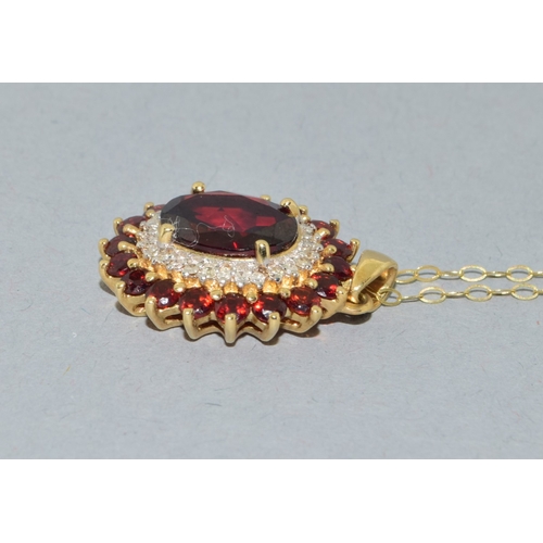 39 - 9ct gold Garnet and Diamond pendant necklace on a 9ct gold chain of 40cm long