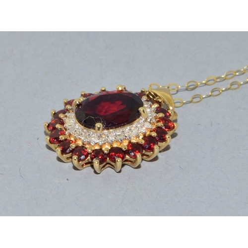 39 - 9ct gold Garnet and Diamond pendant necklace on a 9ct gold chain of 40cm long