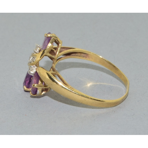 53 - 9ct gold ladies Amethyst twist ring with an open work design size T, 2.4grams