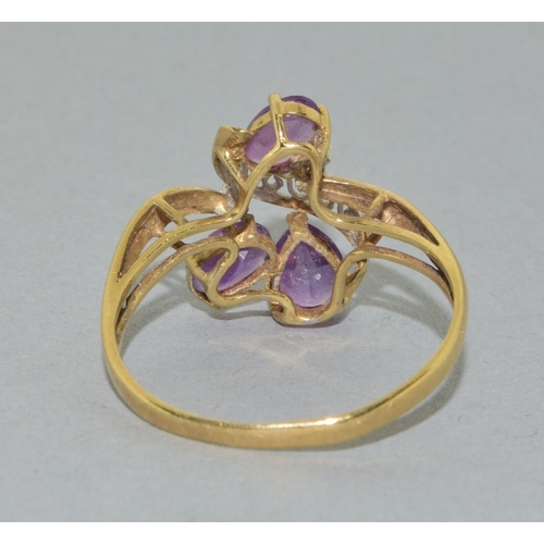 53 - 9ct gold ladies Amethyst twist ring with an open work design size T, 2.4grams
